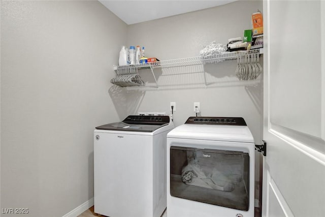 laundry room with laundry area, baseboards, and separate washer and dryer
