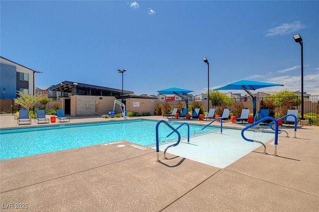 pool featuring a patio area and fence