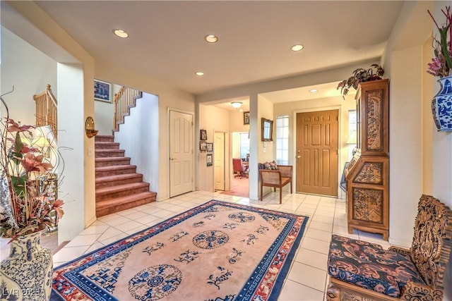 foyer with light tile patterned flooring, recessed lighting, and stairway