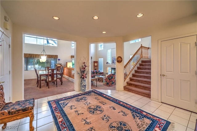 foyer entrance featuring tile patterned flooring, recessed lighting, healthy amount of natural light, and stairway