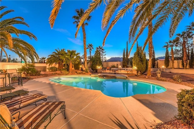 outdoor pool featuring a patio area and a fenced backyard
