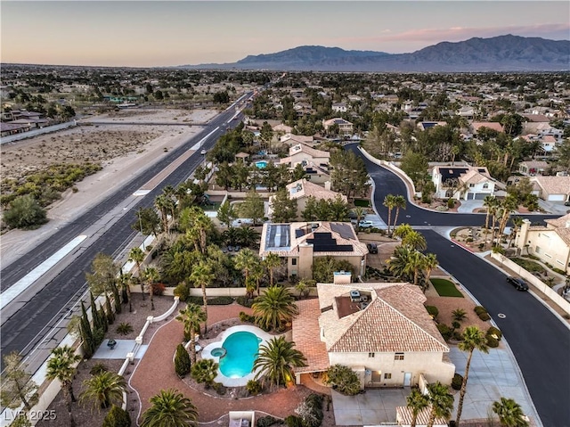 aerial perspective of suburban area with a pool area and mountains