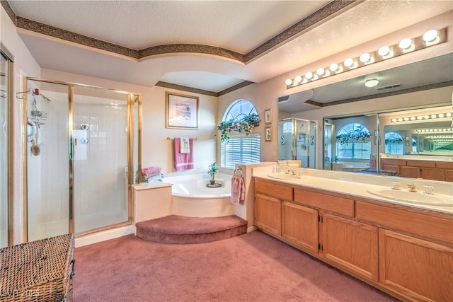 full bathroom featuring a bath, a shower stall, and double vanity