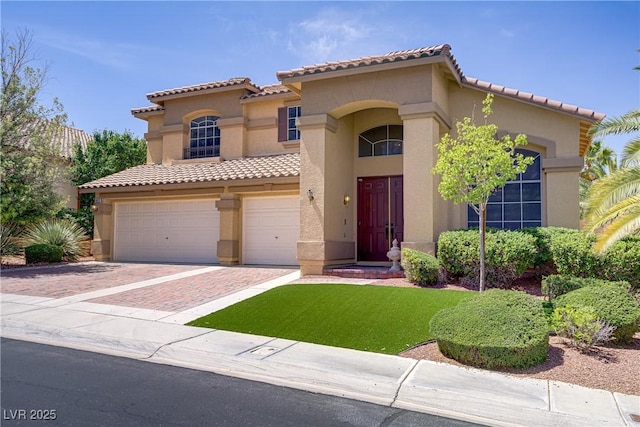 1421 Via Savona Dr, Henderson, NV 89052 - mediterranean / spanish home featuring a garage, stucco siding, decorative driveway, and a tile roof