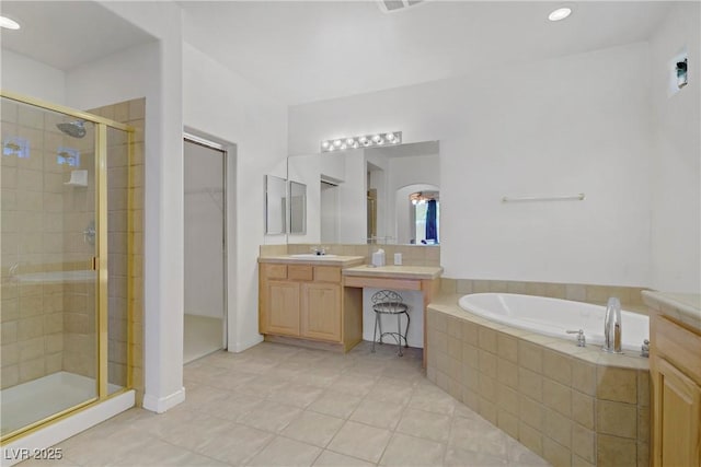 bathroom with vanity, tile patterned flooring, a bath, and a stall shower