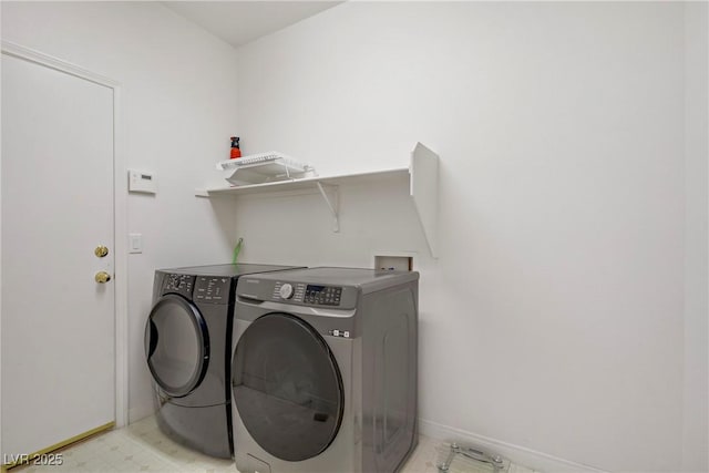 washroom with separate washer and dryer, baseboards, and laundry area