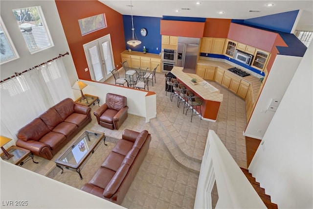 living room featuring recessed lighting, baseboards, high vaulted ceiling, and french doors