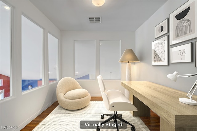 office space with visible vents, wood finished floors, and baseboards