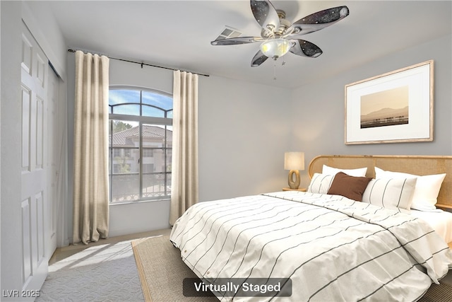 bedroom featuring a closet, light carpet, and ceiling fan