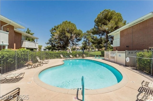 community pool featuring fence and a patio