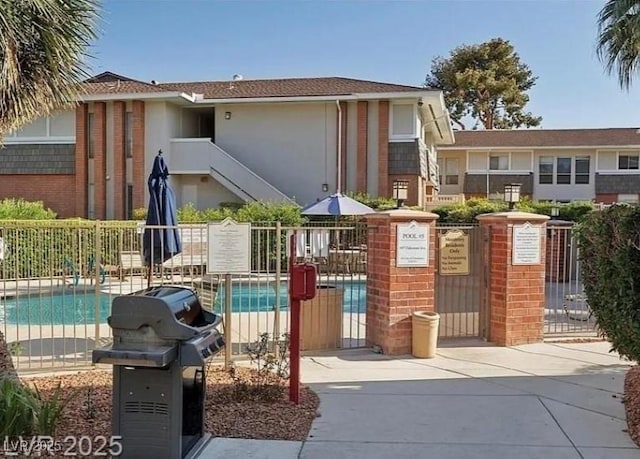 exterior space with a swimming pool and fence