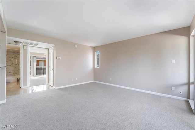 empty room featuring baseboards, carpet, and visible vents