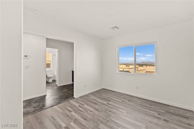10525 Shiny Skies Dr, Las Vegas, NV 89129 - empty room featuring baseboards, visible vents, and wood finished floors