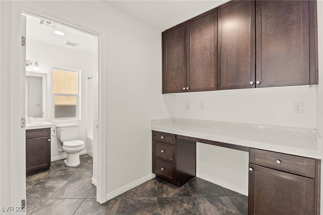 10525 Shiny Skies Dr, Las Vegas, NV 89129 - unfurnished office featuring baseboards, visible vents, and built in study area