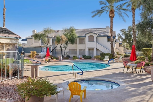 3425 E Russell Rd Unit 202, Las Vegas, NV 89120 - community pool featuring a community hot tub, a patio, and fence