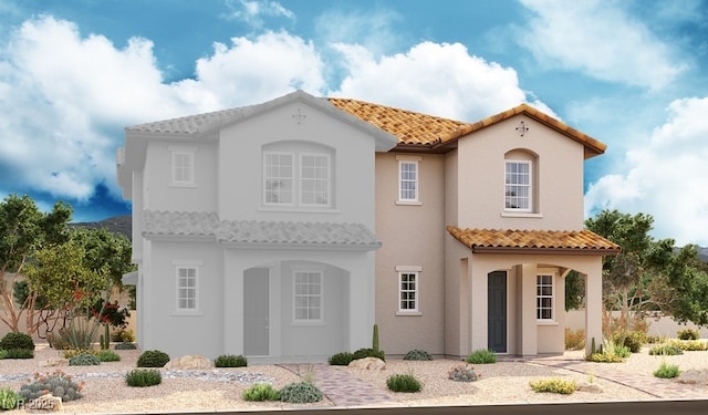 view of front of house featuring a tiled roof and stucco siding