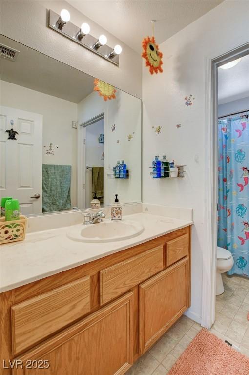 1007 Shades End Ave, North Las Vegas, NV 89081 - bathroom with vanity, toilet, tile patterned flooring, and curtained shower