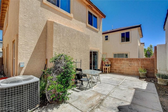 1007 Shades End Ave, North Las Vegas, NV 89081 - rear view of property featuring central AC unit, stucco siding, a patio, and outdoor dining area
