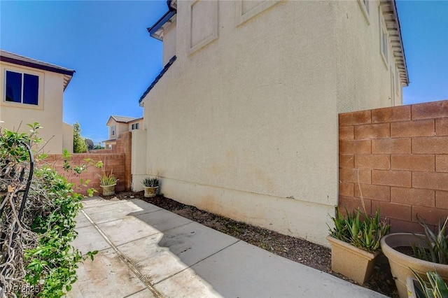 1007 Shades End Ave, North Las Vegas, NV 89081 - view of side of home featuring a patio and stucco siding