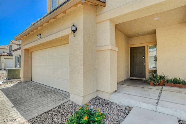 1007 Shades End Ave, North Las Vegas, NV 89081 - property entrance featuring stucco siding, a garage, and driveway