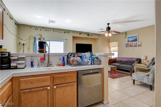 1007 Shades End Ave, North Las Vegas, NV 89081 - kitchen featuring stainless steel dishwasher, open floor plan, a sink, and plenty of natural light