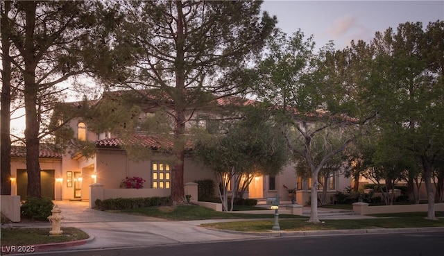 view of front of home with stucco siding and a tiled roof