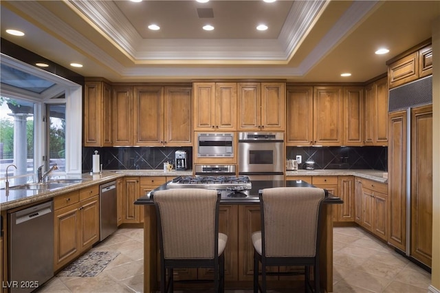 kitchen with a sink, brown cabinetry, paneled refrigerator, stainless steel dishwasher, and ornamental molding