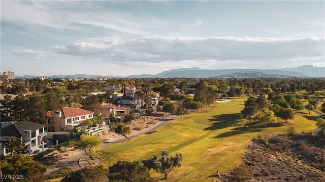 drone / aerial view featuring view of golf course, a residential view, and a mountain view