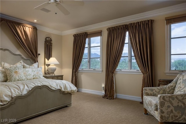 carpeted bedroom with baseboards, ornamental molding, and a ceiling fan