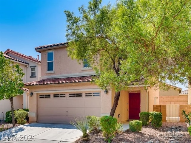 view of front of house featuring a garage, stucco siding, driveway, and a tile roof
