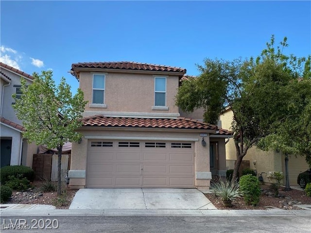 mediterranean / spanish home featuring stucco siding, a tiled roof, driveway, and a garage