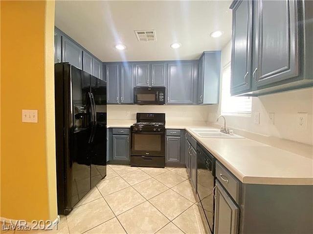 kitchen featuring a sink, light countertops, light tile patterned floors, visible vents, and black appliances