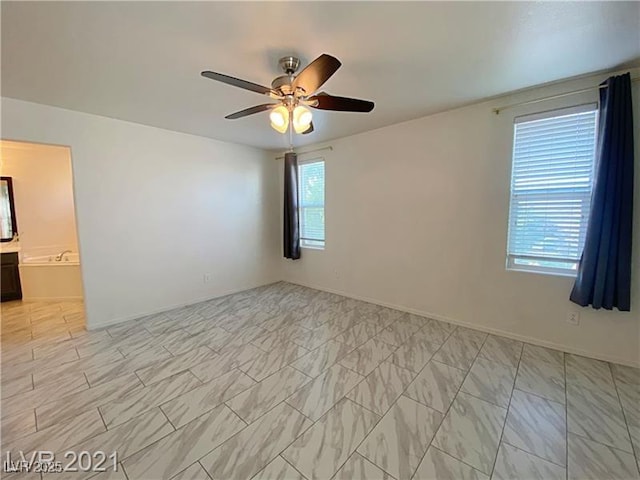 unfurnished room featuring baseboards and a ceiling fan