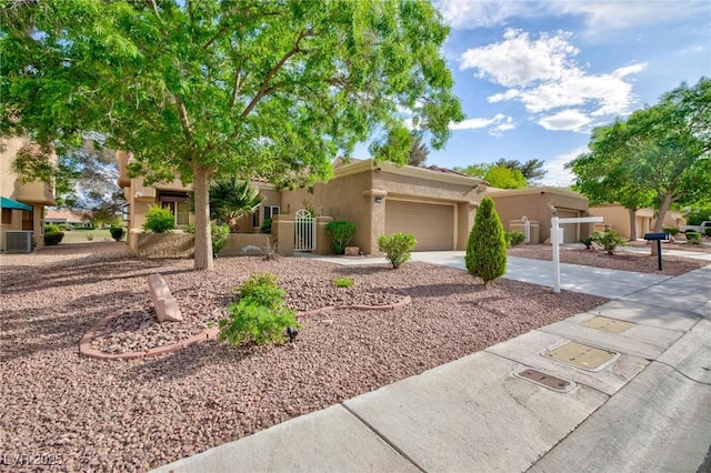 8901 Litchfield Ave, Las Vegas, NV 89134 - view of front facade with an attached garage, central AC unit, driveway, and stucco siding
