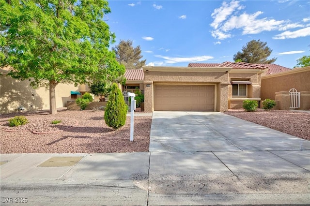 8901 Litchfield Ave, Las Vegas, NV 89134 - view of front of house featuring stucco siding, a garage, and a tiled roof