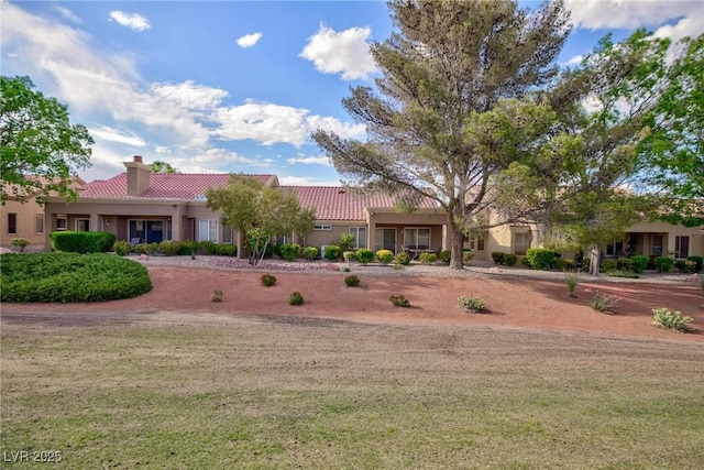 8901 Litchfield Ave, Las Vegas, NV 89134 - ranch-style home featuring a tile roof, stucco siding, a front lawn, and a chimney