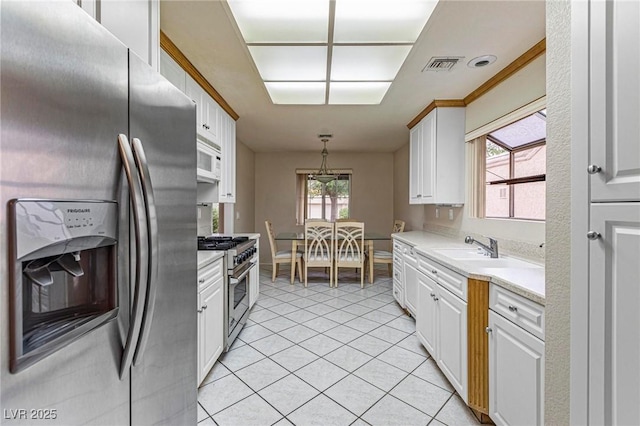 8901 Litchfield Ave, Las Vegas, NV 89134 - kitchen featuring visible vents, white cabinetry, light countertops, light tile patterned floors, and appliances with stainless steel finishes