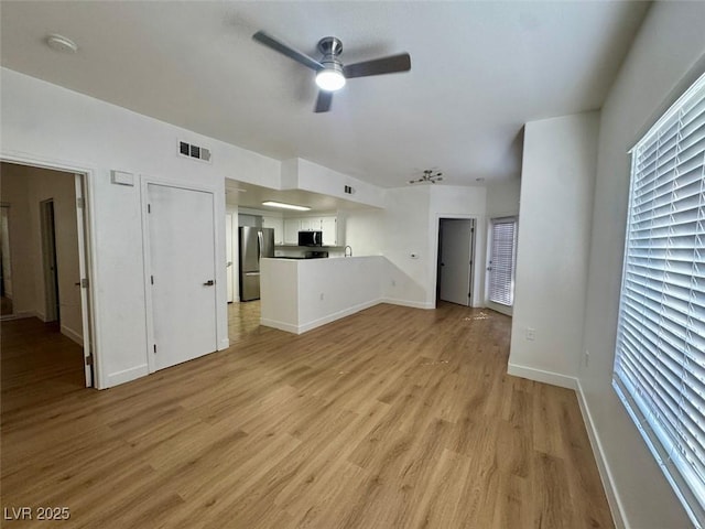 3400 Cabana Dr Unit 1033, Las Vegas, NV 89122 - unfurnished living room with ceiling fan, light wood-style floors, and baseboards