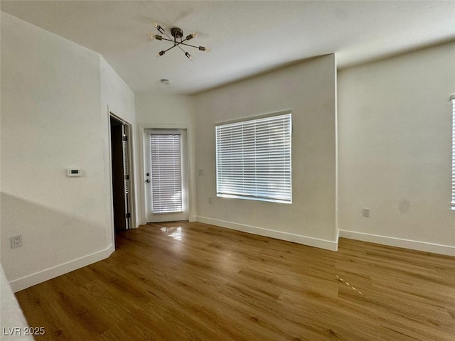 3400 Cabana Dr Unit 1033, Las Vegas, NV 89122 - unfurnished room featuring wood finished floors, baseboards, and plenty of natural light