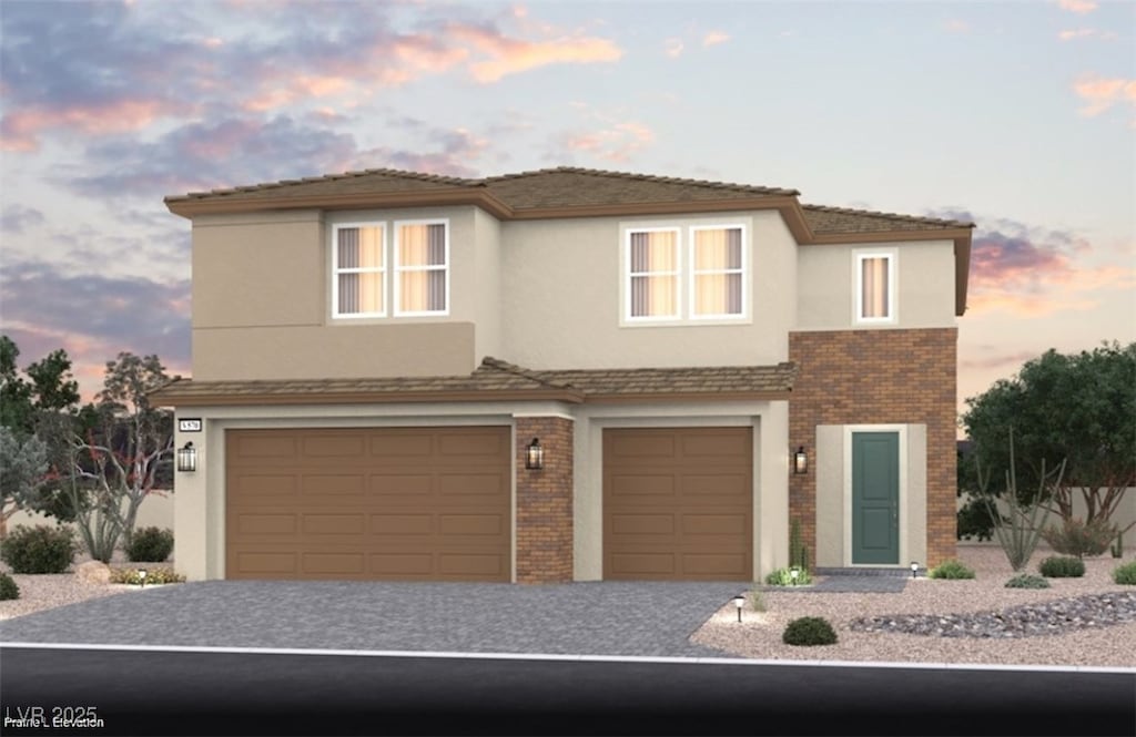 view of front of house featuring brick siding, an attached garage, decorative driveway, and stucco siding