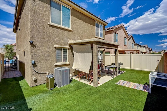 6231 Portland Treaty Ave, Las Vegas, NV 89122 - back of property with a fenced backyard, a patio area, and stucco siding