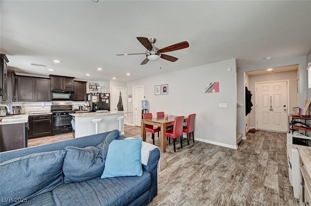 6231 Portland Treaty Ave, Las Vegas, NV 89122 - living room with ceiling fan, light wood finished floors, recessed lighting, baseboards, and visible vents