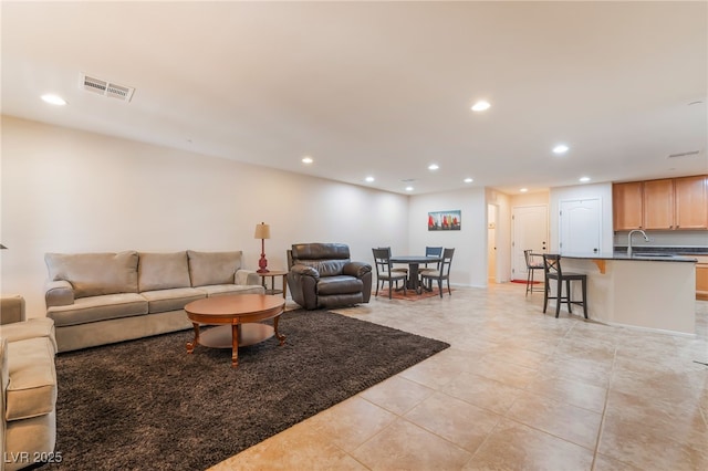living room with recessed lighting, light tile patterned flooring, and visible vents