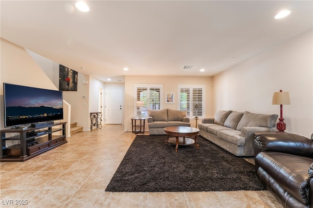 living area featuring recessed lighting, stairs, and visible vents