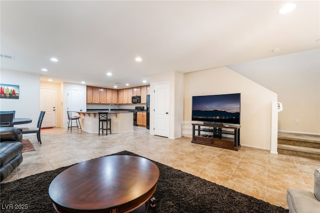 living room featuring stairs, recessed lighting, and light tile patterned flooring