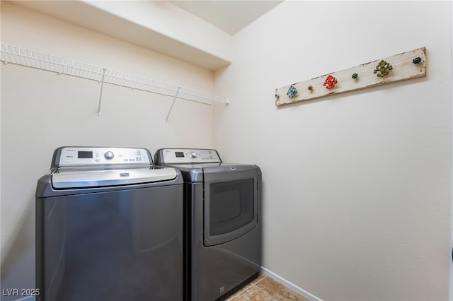 laundry room featuring separate washer and dryer, baseboards, laundry area, and tile patterned floors