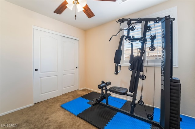 workout area featuring baseboards, a ceiling fan, and carpet