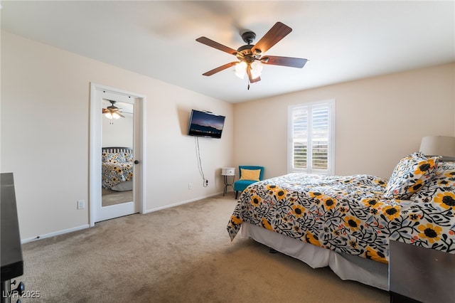 carpeted bedroom featuring baseboards and ceiling fan