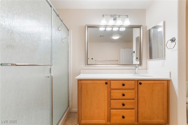 full bath featuring vanity, tile patterned floors, a stall shower, and visible vents
