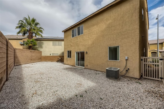 4045 Oliver Sagebrush Dr, Las Vegas, NV 89122 - back of property with a fenced backyard, central air condition unit, stucco siding, and a patio